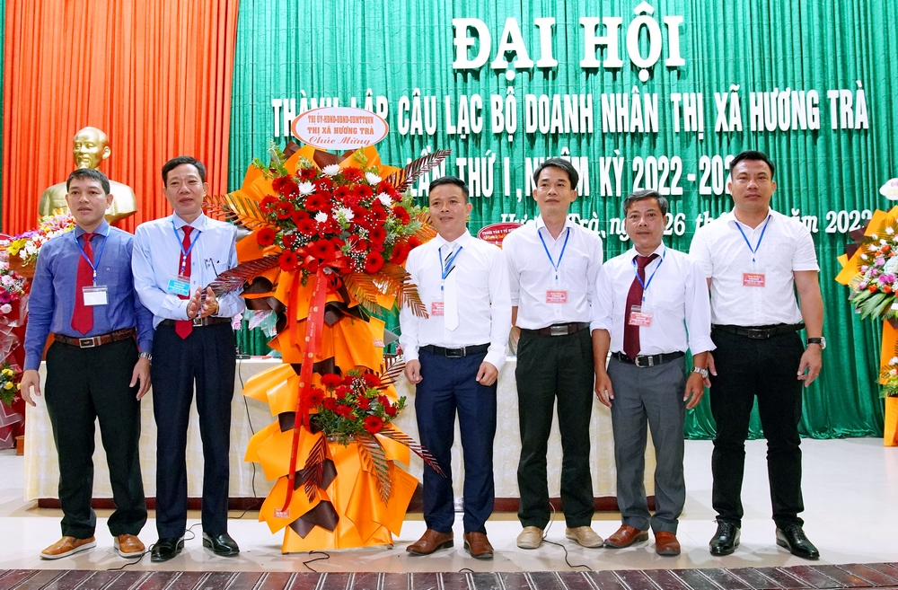 Bí thư Thị ủy Hà Văn Tuấn và Chủ tịch UBND thị xã Nguyễn Duy Hùng (ngoài cùng bên trái) tặng hoa chúc mừng Đại hội.